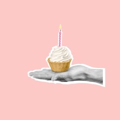 Human hand holding a sweet tasty cupcake with candle.