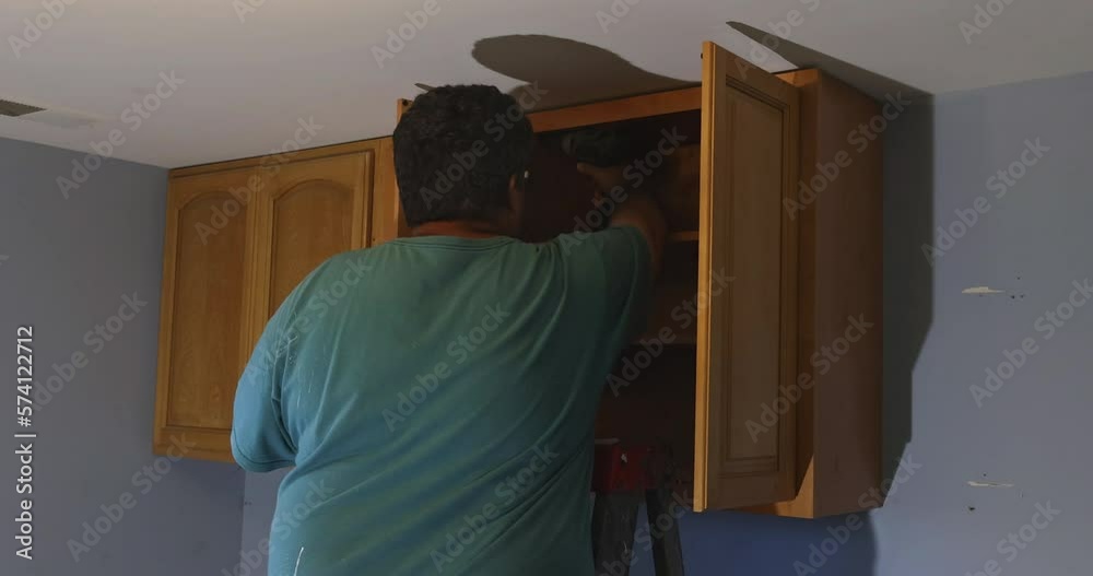 Assembly and installation of modern kitchen cabinets on new house Assembly and installation of modern kitchen cabinets on new house