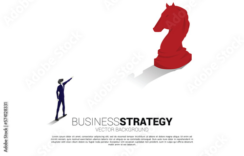 Silhouette of businessman point forward with chess piece. concept of business strategy marketing.