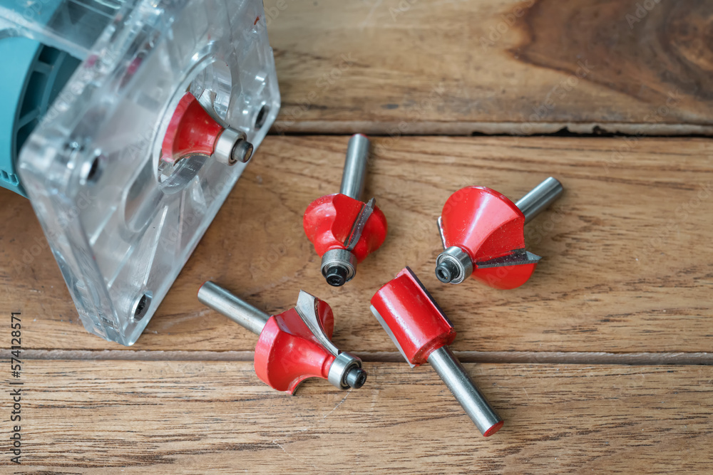Router Bit and Trimmer router for Wood on wooden background, DIY maker and woodworking power tools concept. selective focus