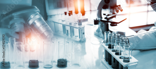 Double exposure microscope and Young woman scientific using equipment in the laboratory for research.Biotechnology,development,chemical,vaccine,COVID-19. Photo concept experimentation and research.