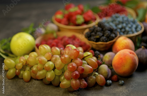 Fototapeta Naklejka Na Ścianę i Meble -  berry mix. A variety of summer berries - grape, raspberries, strawberries, blueberries, cherries, currants, plums - in cups on a wooden table