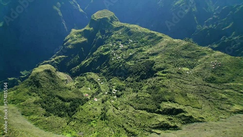 Drone slowly flies over little houses in the huge crater of Cirque du mafate in La Reunion french Island photo