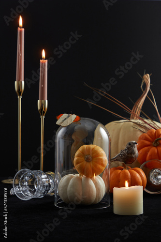 Halloween decoration in modern style. candles and pumpkins in the dark background. Photo zone for Halloween