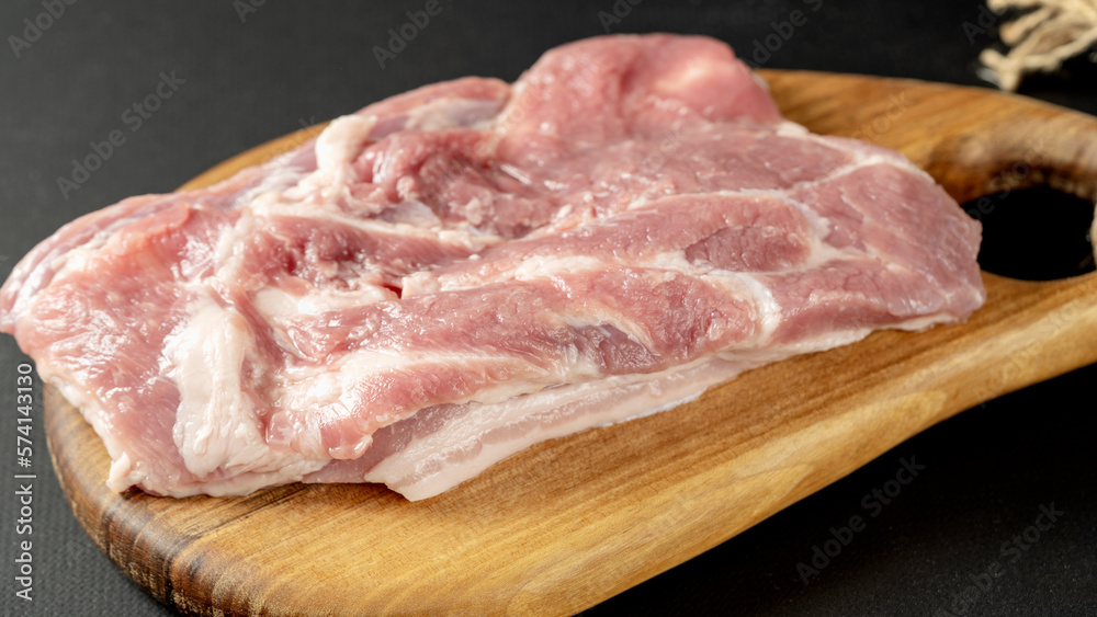 The concept of cooking meat. The chef cook salt on the cooked steak on a black background, a place under the logo for the restaurant menu. food background image, copy space text The concept of cooking meat. The chef cook salt on the cooked steak on a black background, a place under the logo for the restaurant menu. food background image, copy space text