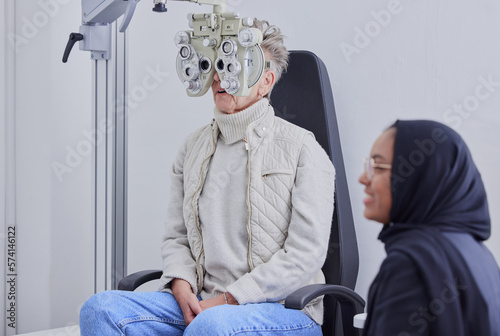 Photography Optometry, ophthalmology and Islamic optometrist in Dubai consulting a patient for an eye test using a Phoropter for vision