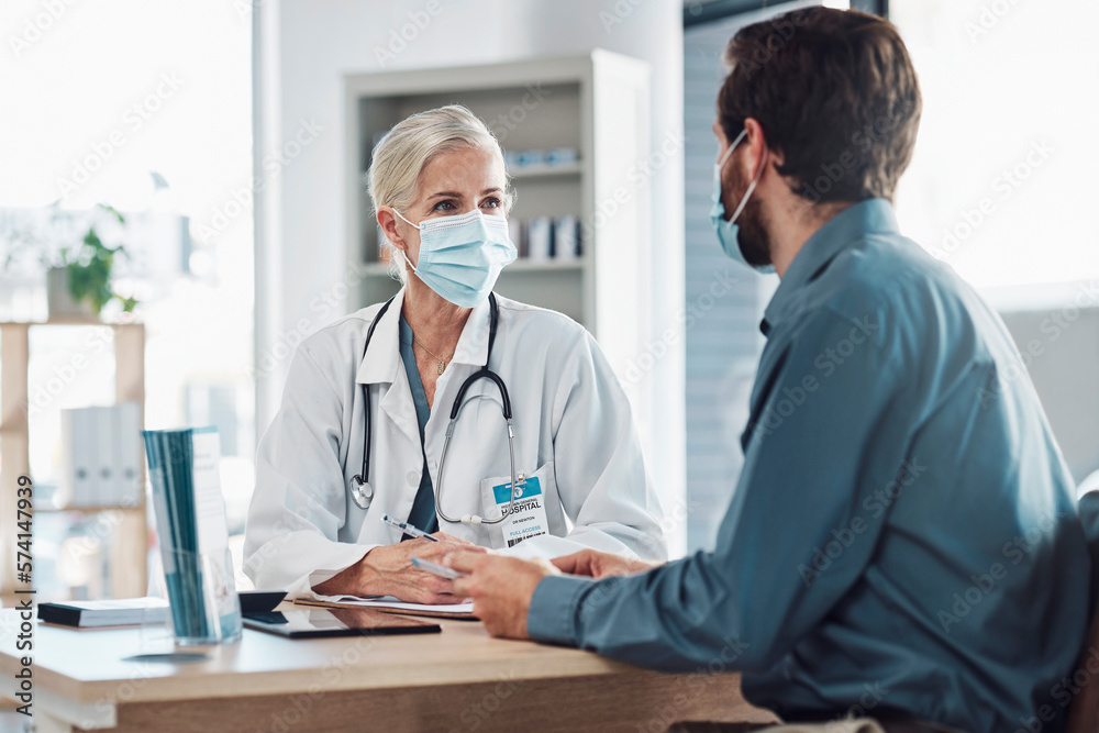 Consultation, covid and doctor with a man for healthcare, medical attention and service. Medicine, support and consultant with a face mask for virus while talking to a patient about health results Consultation, covid and doctor with a man for healthcare, medical attention and service. Medicine, support and consultant with a face mask for virus while talking to a patient about health results