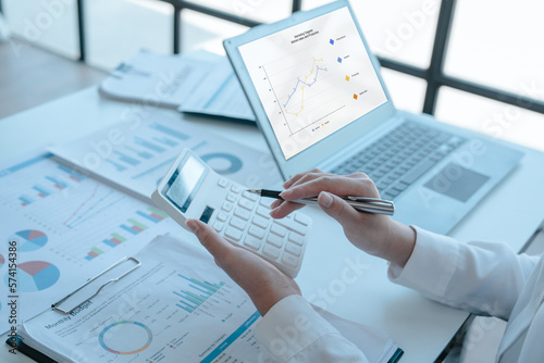 Close up accountant working on consolidated financial report of corporate operations, consultant auditing finance data (balance sheet, income statement) fintech.