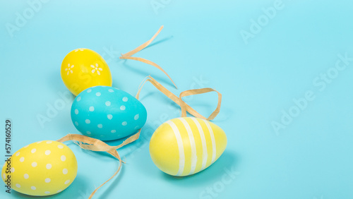 Happy easter banner. Yellow Easter eggs on a pastel blue background