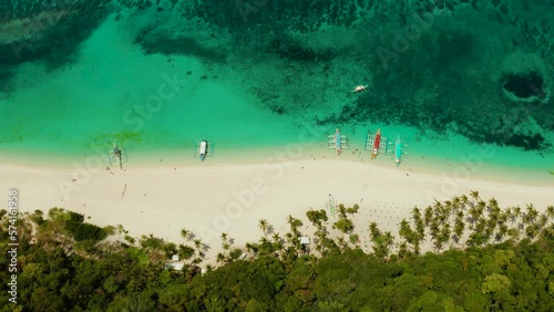 Tropical white sand beach, near the blue lagoon and corall reef from above, Boracay, Philippines. Sandy beach with tourists. Summer and travel vacation concept. photo