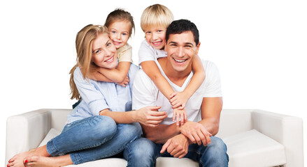 Beautiful smiling family sitting at sofa at home