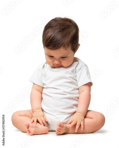 Cute baby in white onesie on white background