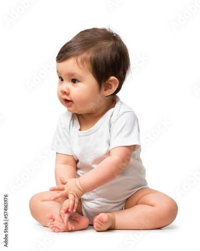 Cute baby in white onesie on white background