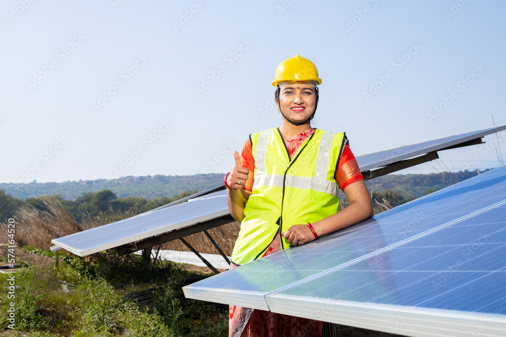 Portrait of Young indian woman technician wearing yellow hard hat