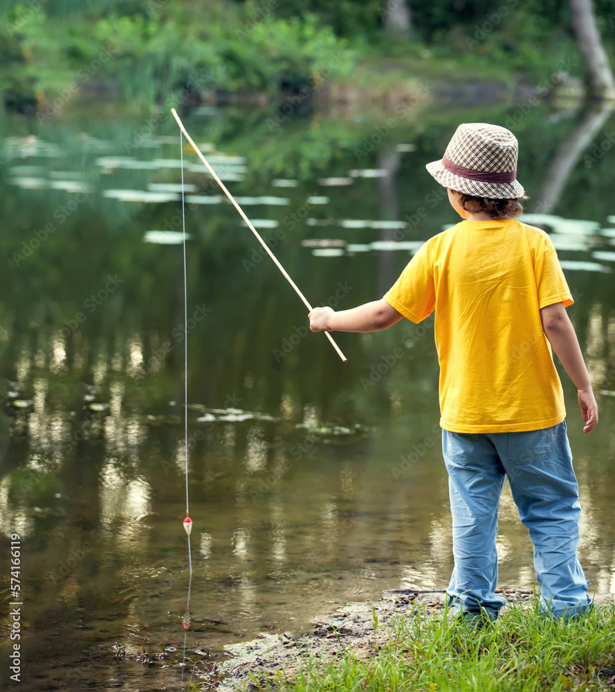 Happy boys go fishing on the river, Two children of the fisher with a fishing rod on the shore of lake Happy boys go fishing on the river, Two children of the fisher with a fishing rod on the shore of lake