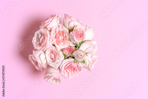 Delicate blooming pink flowers  blooming roses festive pink background  pastel bouquet with floral card  selective focus