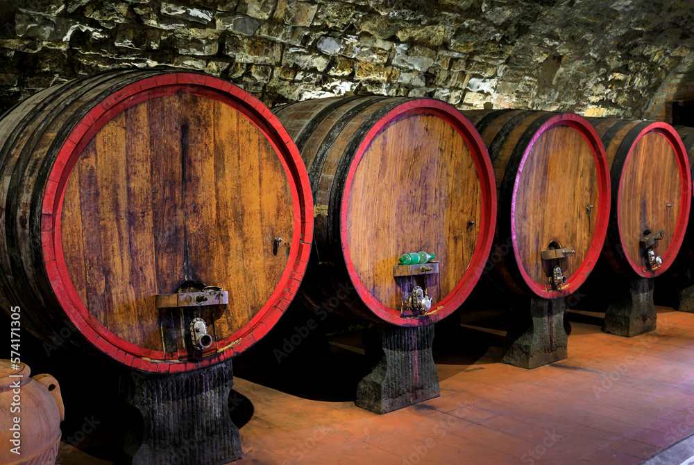 Chianti wine from Sangiovese grapes aging in wooden barrels at a vineyard in the famous wine producing Chianti Classico Region of Tuscany, Italy