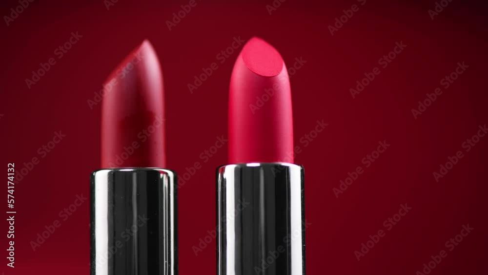 Lipstick. Fashion red Colorful Lipsticks over red background. Red lipstick tints palette, Professional Makeup and beauty. Beautiful Make-up concept. Lipgloss. Rotating Lipsticks closeup Lipstick. Fashion red Colorful Lipsticks over red background. Red lipstick tints palette, Professional Makeup and beauty. Beautiful Make-up concept. Lipgloss. Rotating Lipsticks closeup