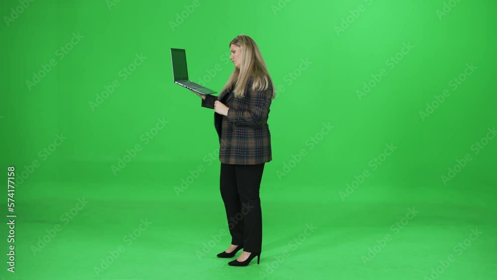 Woman user typing and uses laptop on the go, manager on a green background, chromakey template. Woman user typing and uses laptop on the go, manager on a green background, chromakey template.