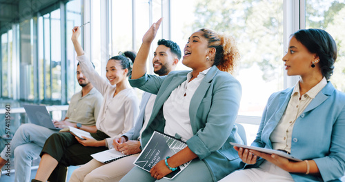 Interview, question and training with a business black woman raising her hand to answer during a meeting. Recruitment, human resources and hiring with a candidate group sitting in a row at an office