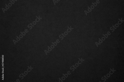 Black paper texture background. Black blank cardboard sheet page. Old vintage page dark grunge vignette. Pattern rough art rustic grunge letter. Material cardboard with copy space for luxury text.