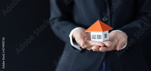 Real estate agent with house model, Home sales and home insurance concept.