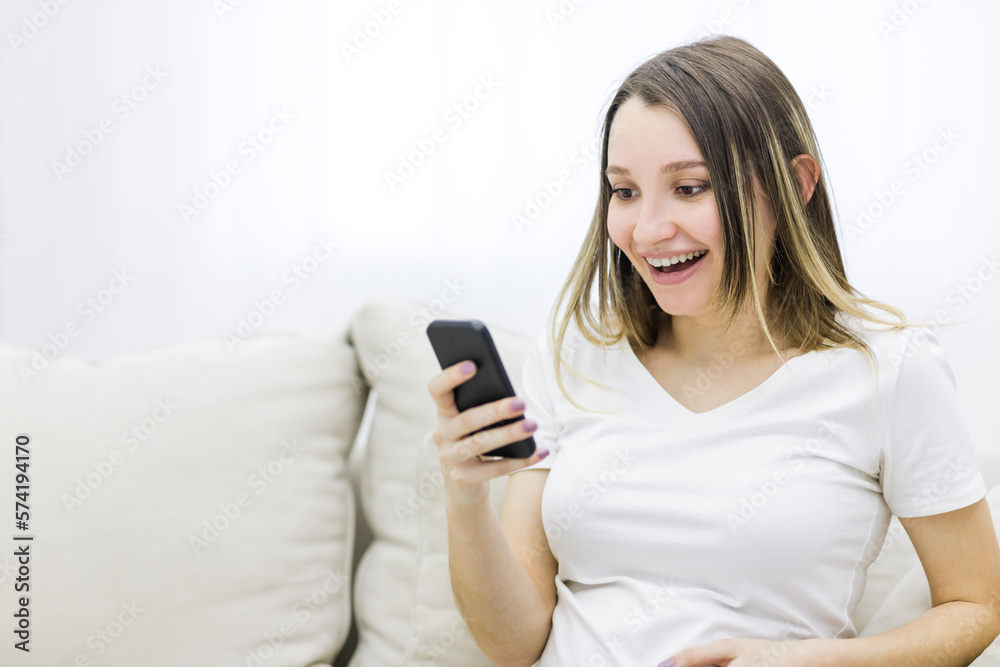 Close-up photo of beautiful pregnant woman looking at the phone. Close-up photo of beautiful pregnant woman looking at the phone.