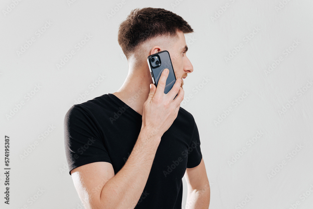 Happy caucasian young man using smart phone cellphone for calls, social media, mobile application online isolated in white background Happy caucasian young man using smart phone cellphone for calls, social media, mobile application online isolated in white background