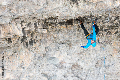 Woman rock climbing cave route called Zero to Hero at Hall of Justice cave, Camp Bird Road, Uncompahgre National Forest, Ouray, Colorado, USA photo