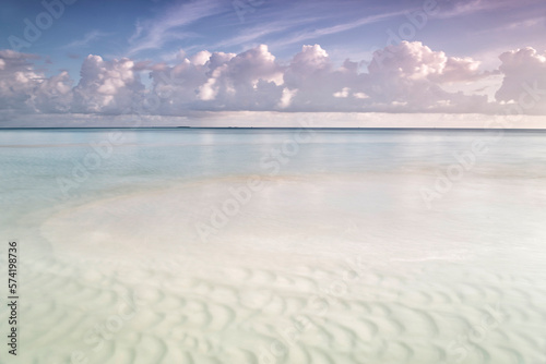 Sunrise on the beach paradise island Gulhi. Indian Ocean, Maldives photo