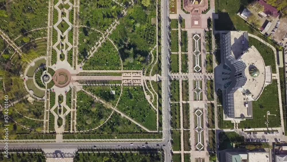 Aerial ascending cenital shot in Dushanbe city, Tajikistan over Rudaki park and national library.