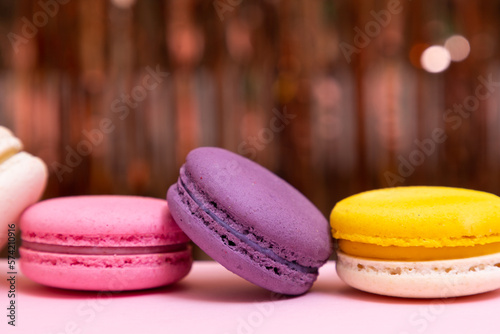 Sweet colorful macarons  on pink background. Tasty colourful macaroons. High quality photo