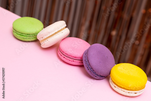 Sweet colorful macarons  on pink background. Tasty colourful macaroons. High quality photo