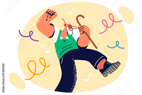 Elderly man with gray beard leads energetic lifestyle and dances enjoying holiday and birthday party