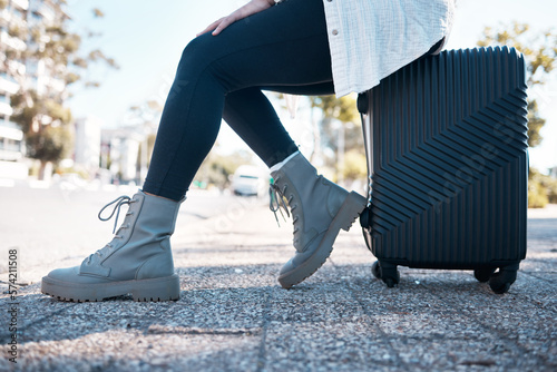 Travel, city and shoes of woman with suitcase ready fpr destination holiday, weekend and vacation. Traveling, journey and feet of girl in urban street with luggage waiting for cab, taxi or transport