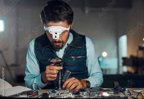 Photography Technician, engineer and IT professional repair motherboard, microcircuit or electronic device in a workshop or shop