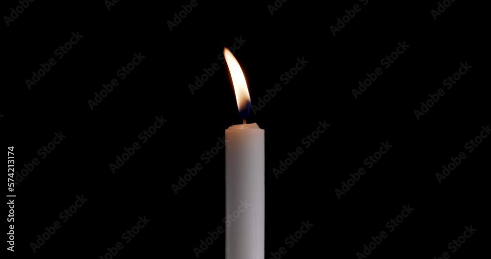 Candle on a black background. The flame of the candle slowly flickers. One candle slowly flickers. Ideal for background or over-layer with blending mode add, screen, Lighten. Candle on a black background. The flame of the candle slowly flickers. One candle slowly flickers. Ideal for background or over-layer with blending mode add, screen, Lighten.