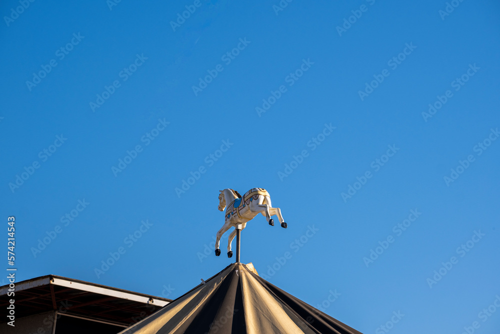 Horse on a carousel with blue sky in the background