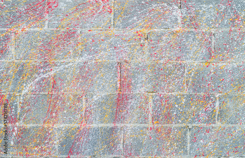 Concrete block wall background and texture.Colorful Concrete block wall as background,color painting on concrete block wall .Dropping acrylic paint on the concrete wall.Street art - graffiti.