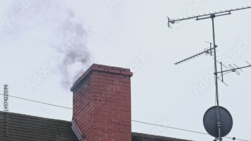 Dark Toxic Smoke Coming Out of House Roof Chimney Polluting Air and Creating Smog in the City