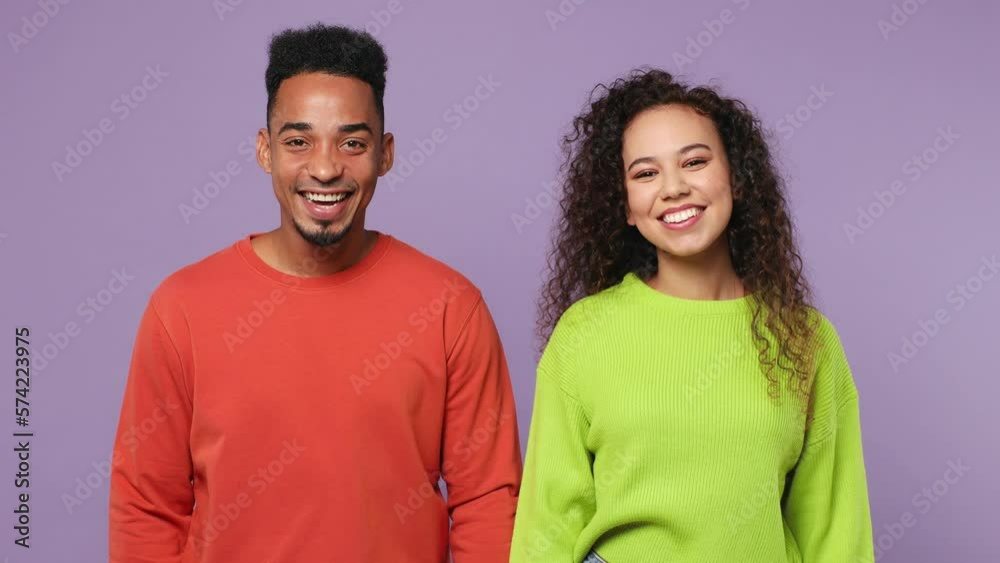 Young couple two friends family man woman of African American ethnicity wear casual clothes together meeting together greeting giving high five clap hands folded isolated on plain purple background Young couple two friends family man woman of African American ethnicity wear casual clothes together meeting together greeting giving high five clap hands folded isolated on plain purple background