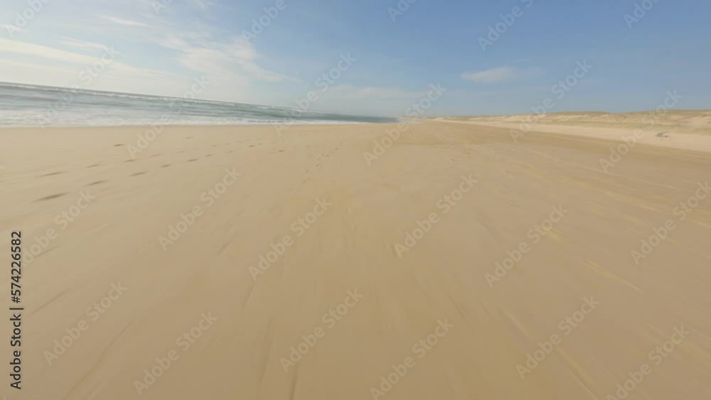 Aerial fpv racing drone flying over sandy beach and sea waters, Landes department in France Aerial fpv racing drone flying over sandy beach and sea waters, Landes department in France