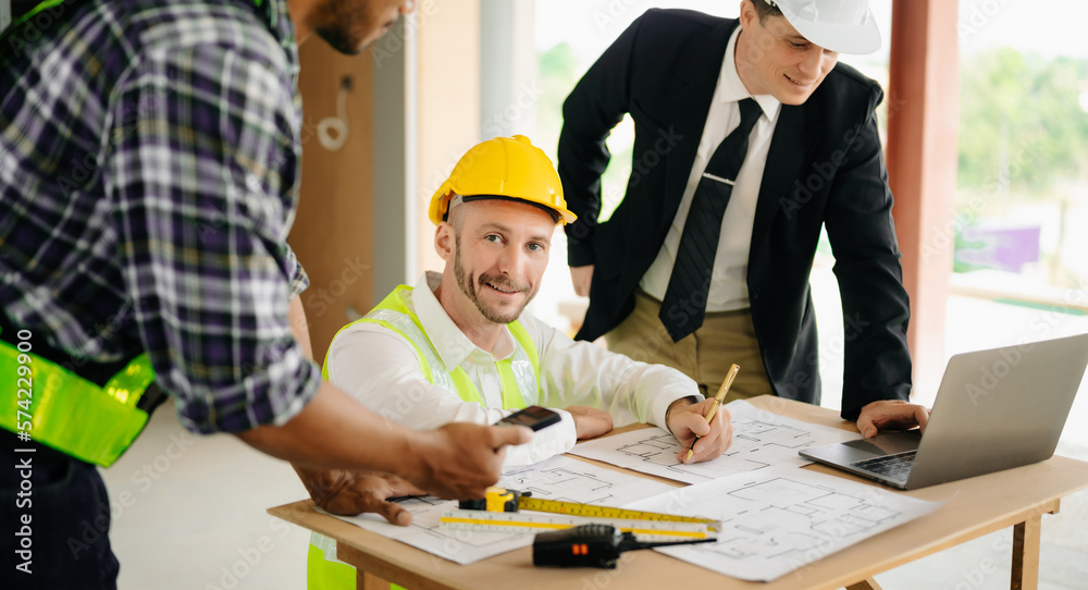 Architect caucasian man working with colleagues mixed race in the construction site. Architecture engineering on big project. Building in construction process . Architect caucasian man working with colleagues mixed race in the construction site. Architecture engineering on big project. Building in construction process .