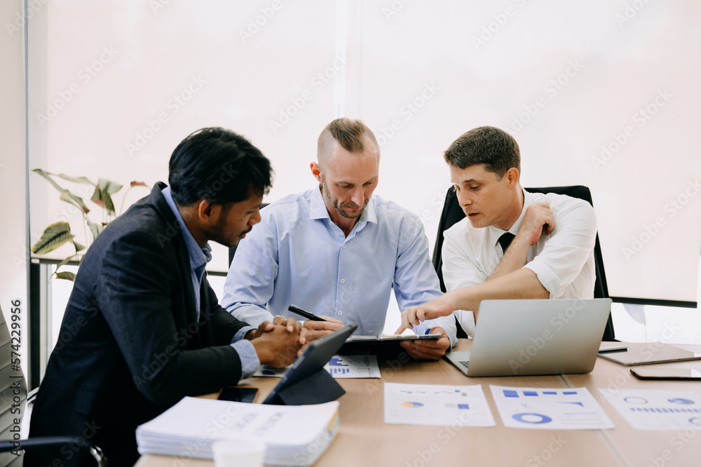 Office colleagues have a casual discussion. During a meeting in conference room, a group of business teem sit in the conference room new startup project.. Office colleagues have a casual discussion. During a meeting in conference room, a group of business teem sit in the conference room new startup project..