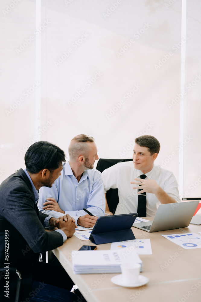 Office colleagues have a casual discussion. During a meeting in conference room, a group of business teem sit in the conference room new startup project.. Office colleagues have a casual discussion. During a meeting in conference room, a group of business teem sit in the conference room new startup project..