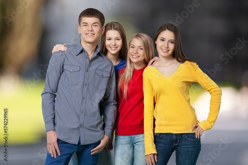 Multiracial happy student friends posing on outdoor