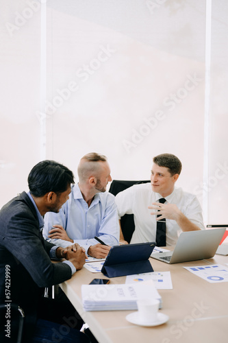 Office colleagues have a casual discussion. During a meeting in conference room, a group of business teem sit in the conference room new startup project.. © Nuttapong punna