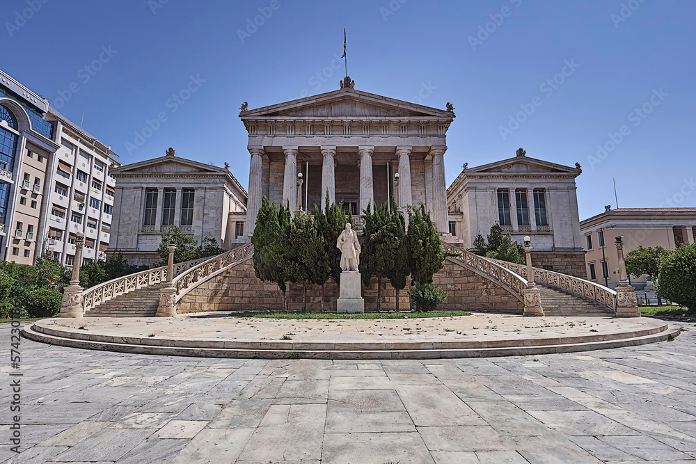 The old National Library white marble front, with impressive double stairs, doric rhythm columns and the statue of the great donor Valianos. Cultural travel to Athens, Greece.
