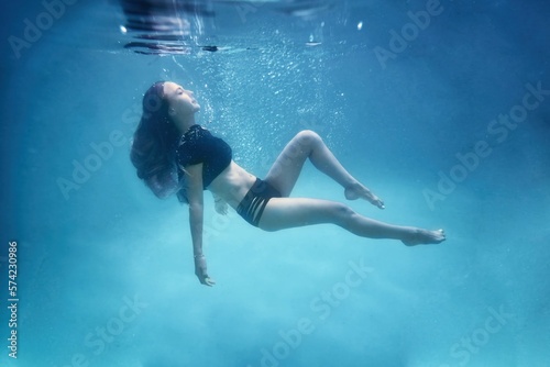 The girl is under water. Water photography.