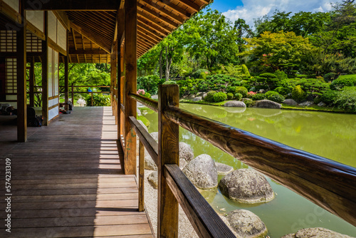 The wooden traditional japanese building and pond of the japanese garden in Compans Caffarelli, Toulouse (France) photo